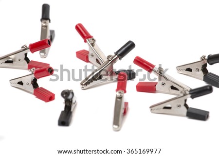 Creative display of several alligator clippers on a white background.