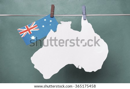Australian map flag hanging on pegs ( clothespin ) yellow background. Australia. Concept - wishes for the holidays, information text. toned colored
