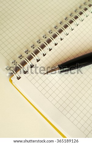 Notebook with blank pages and black pen in retro tone