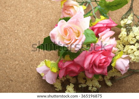 Fabric roses on bulletin / cork board. Natural background. Focus on dark pink roses. Space for texts.