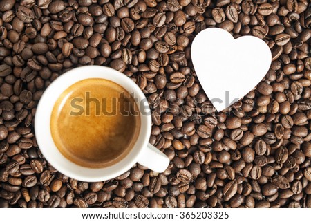 Coffee for Valentine's day.. Coffee cap and heart on the beans background