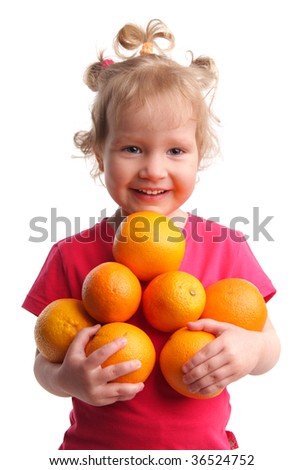 Happy little girl with oranges on a white background