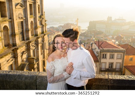 Newlyweds in beautiful expensive dresses in the background of the city of Porto, Portugal