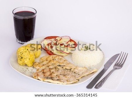 Filet grilled chicken with tomatoes, potatoes, rice and special sauce. Drink aside: chicha morada (ppurple corn refreshment). Picture taken in Peru. 