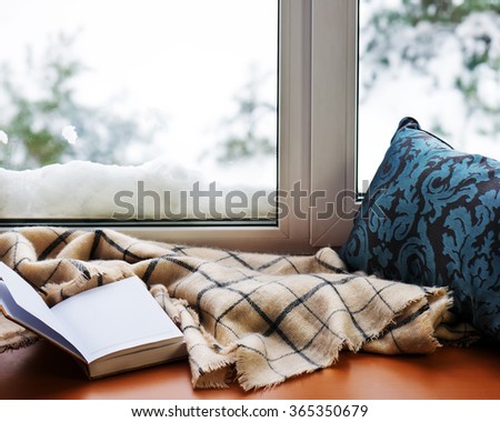 Open notepad, pillow and beige warm plaid located on stylized wooden windowsill. Winter concept of comfort and relaxation
 Royalty-Free Stock Photo #365350679