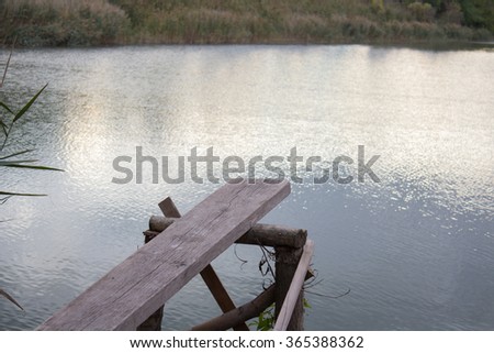 old wooden springboard over the water at the lake
