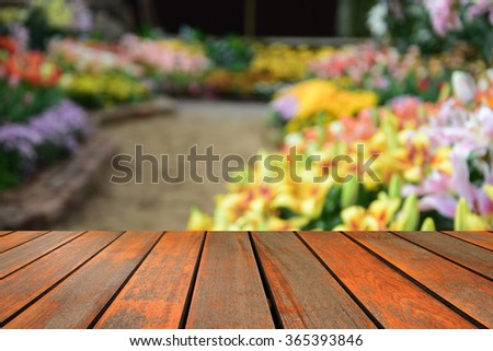 blurred image wood table and abstract background of flowers
