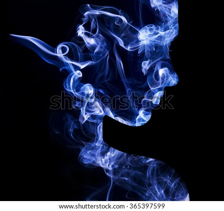 Abstract double exposure portrait of young woman face and cigarette smoke. Woman face silhouette from smoke. Smoke face on black background. Double exposure woman face and smoke 
