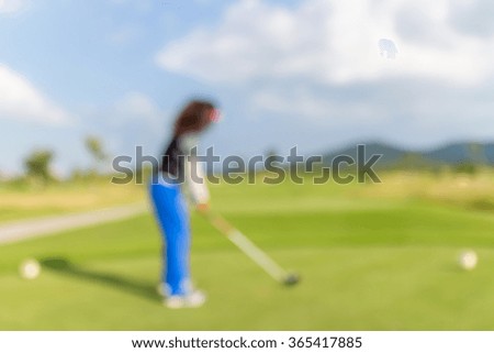 Blurred photo of woman golf player on green during golf match.