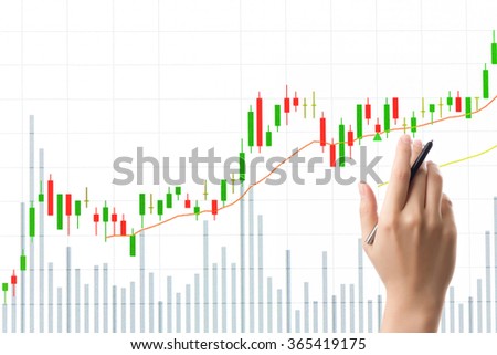 Hand with pen pointing stock market candle graph analysis on the white screen.
