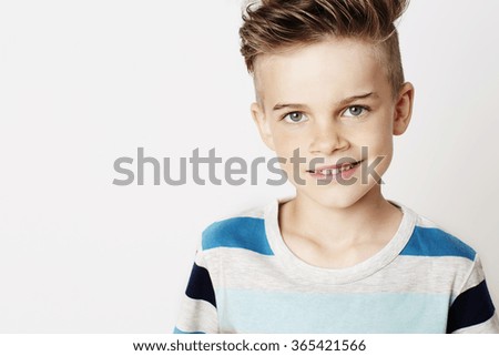 Smiling young kid in white studio