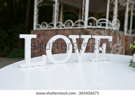 Decor word LOVE on table wedding ceremony