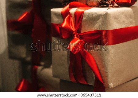 stylish craft gift boxes with red ribbons in window shop, seasonal holiday present concept