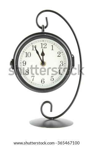 clock suspended on an iron stand. Isolated