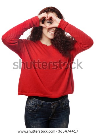 girl peeking through heart shape hand sign 