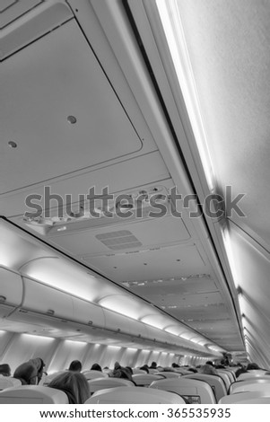 Italy, people in an airplane cabin with no smoking sign on