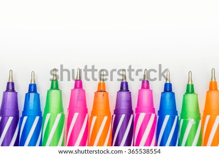 Multicolored pen on white background