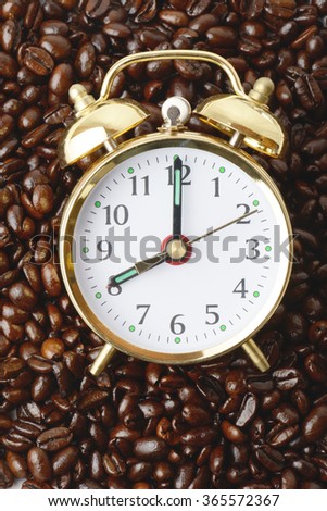 a clock on a bed of coffee beans