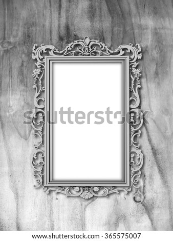 Close-up of one silver Baroque picture frame on monochrome weathered wooden background