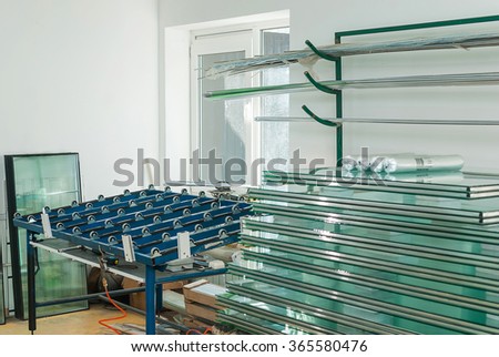 Sheets of Factory manufacturing tempered clear float glass panels cut to size Royalty-Free Stock Photo #365580476