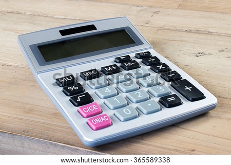 Calculator.
Wooden background.