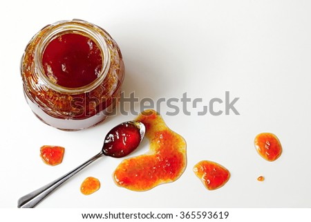 Homemade jam made from the orange berries of sea buckthorn on a white background. Photo above.