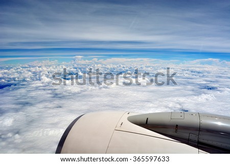 A picture of a plane engine up in the sky with the Earth and blue sky in the background