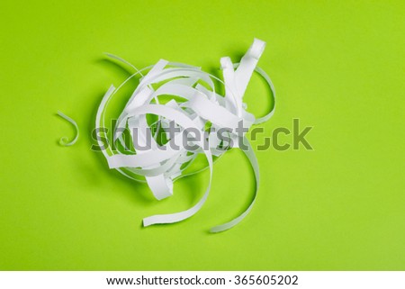 Pieces of white torn paper over the green background