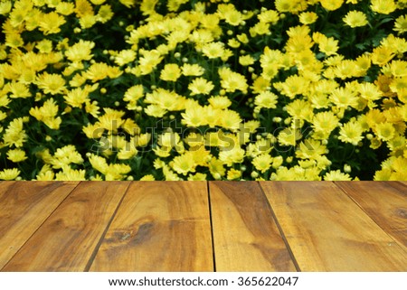 blurred image wood table and abstract background of flowers