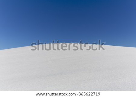 Snow field with blue sky and text space