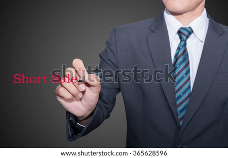 Short Sale - Young businessman, with text written with the hand.
