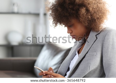 Young african american business woman using a smartphone