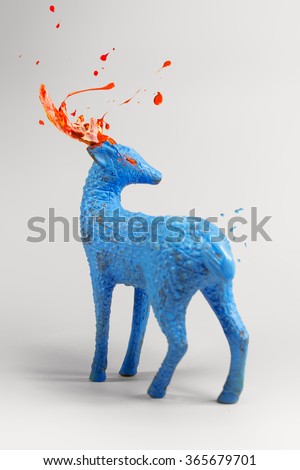 Mysterious blue deer with bursting orange paint horns