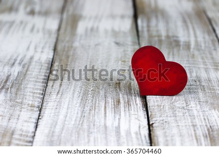 Red wood heart on white painted rustic antique wooden background; Valentine's Day and love concept