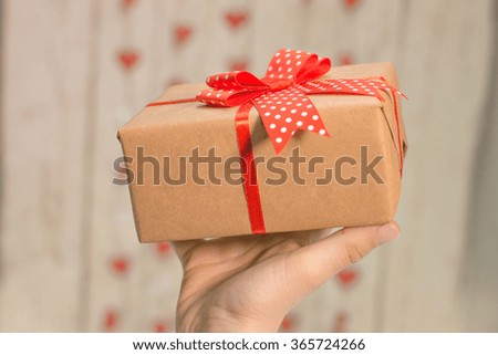 Hands holding a valentine's gift box  