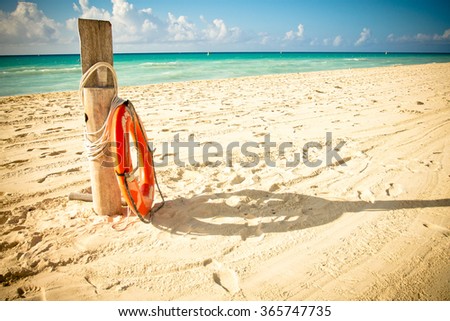 Lifesaver beside a trunk on a caribbean Beach. Taken at Mayan Riviera,Mexico.