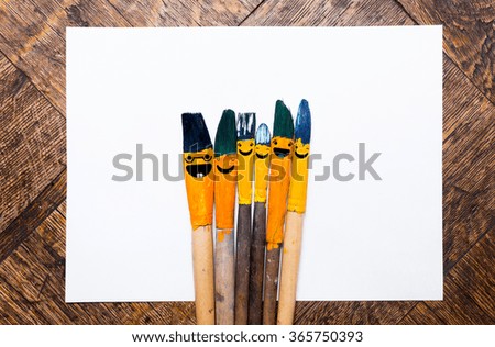 Paintbrushes with white paper.Template for fun design concept. Brush colored in blue - orange.