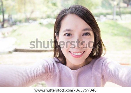 young woman smile take selfie. nature green background, asian beauty