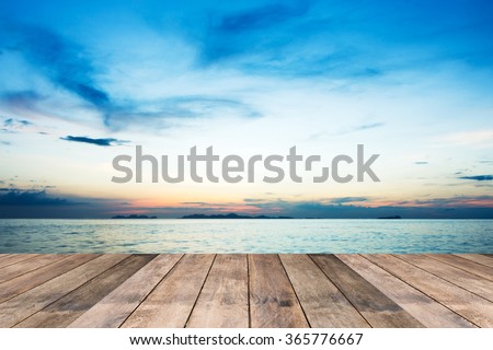 Perspective of wood terrace against beautiful seascape at sunset with free copy space use for background or backdrop. Royalty-Free Stock Photo #365776667