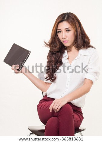 Beautiful Asian woman holding tablet on white background.