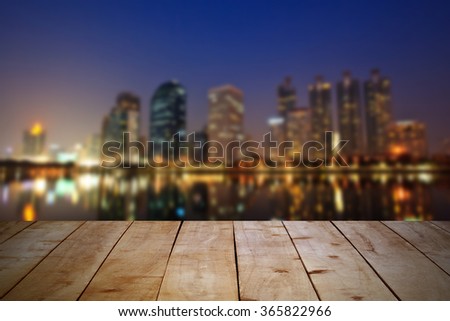 Empty wooden table at night city landscape. Can put your products for display.