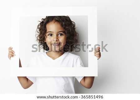 Cool young guy holding white picture frame, portrait