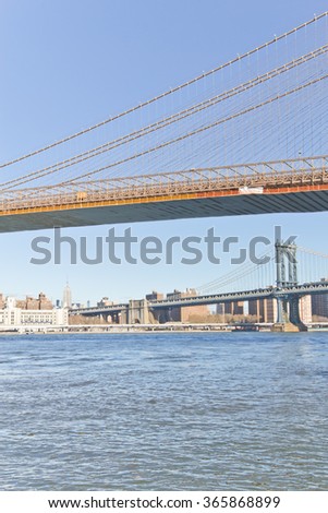 Brooklyn Bridge on winter morning with manhattan buildings in background.