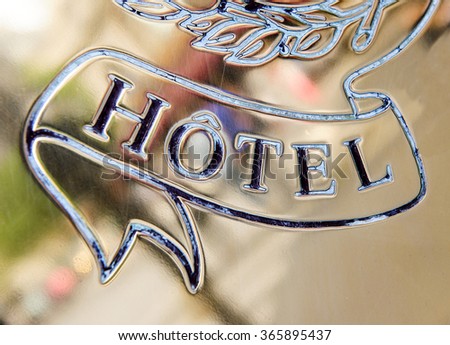 Detail of a hotel signage on gold background and beautiful engraving
