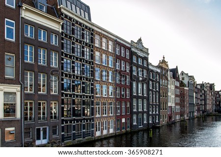 Amsterdam City Scene. Visible are many typical dutch houses. Old 17th and 18th century brick houses along a canal in center of Amsterdam, Netherlands.