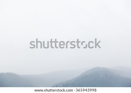Foggy mountains in winter time outside photo