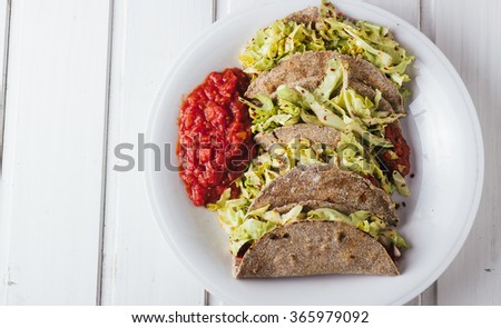 Vegan tacos on white wooden background