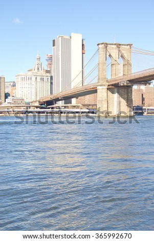 Brooklyn Bridge on winter morning with manhattan buildings in background.