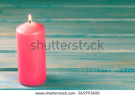  light  burning brightly candles on old wooden background. Spa, meditation, ritual, flavored. turquoise color