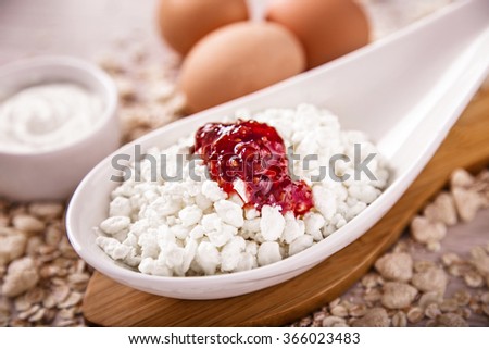 Cottage cheese with jam, eggs on the background of scattered muesli. Picture taken in the studio